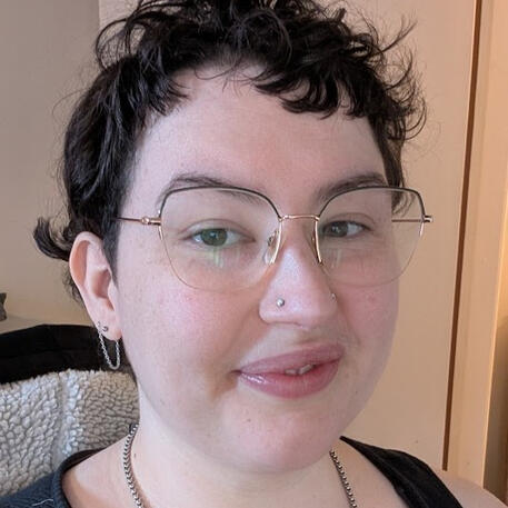 A selfie of Norah. She is white with dark hair and glasses.